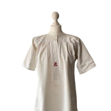 antique white linen Victorian chemise on a mannequin with red embroider MS or SM against a white background