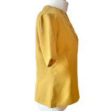 Yellow 1940s 50s blouse on a mannequin with a white background