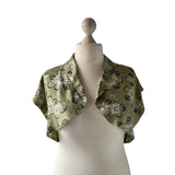 True vintage 1950's bolero jacket in a green beige and black Rayon satin floral print. at hurdyburdy vintage clothing shop