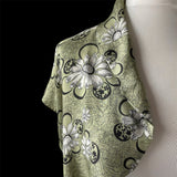 True vintage 1950's bolero jacket in a green beige and black Rayon satin floral print. at hurdyburdy vintage clothing shop