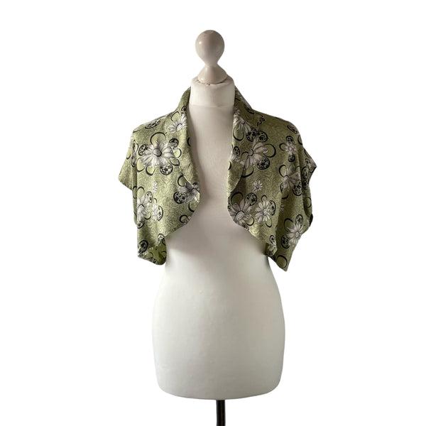 True vintage 1950's bolero jacket in a green beige and black Rayon satin floral print. at hurdyburdy vintage clothing shop