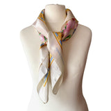Floral Pierre Balmain vintage satin scarf with decorative border and pink lily print on a mannequin against a white background