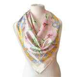 Floral Pierre Balmain vintage satin scarf with decorative border and pink lily print on a mannequin against a white background