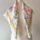 Floral Pierre Balmain vintage satin scarf with decorative border and pink lily print on a mannequin against a white background
