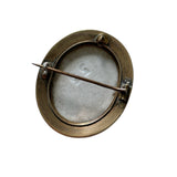 Antique brooch with brass frame and clasp on white background
