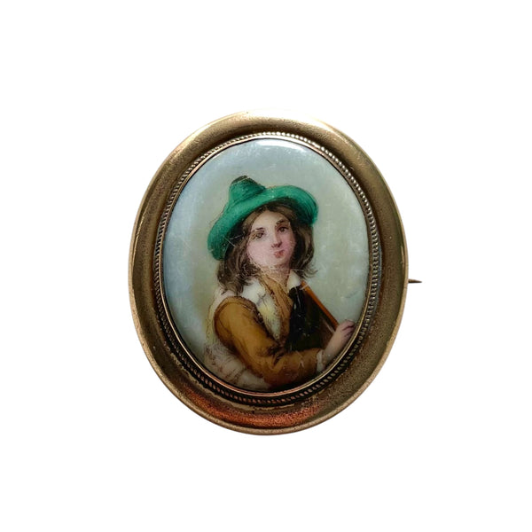 Vintage brooch with a portrait of a  Hand Painted Antique Victorian Tyrolean boy in a green hat on a white background