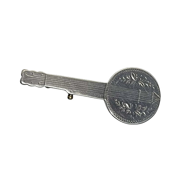 antique Silver banjo brooch on a black background