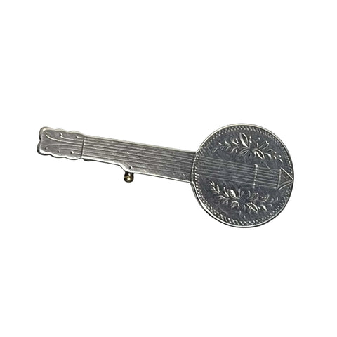 antique Silver banjo brooch on a black background