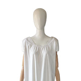 White sleeveless antique chemise on a mannequin against a white background