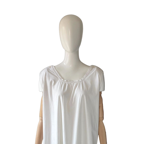 White sleeveless antique chemise on a mannequin against a white background