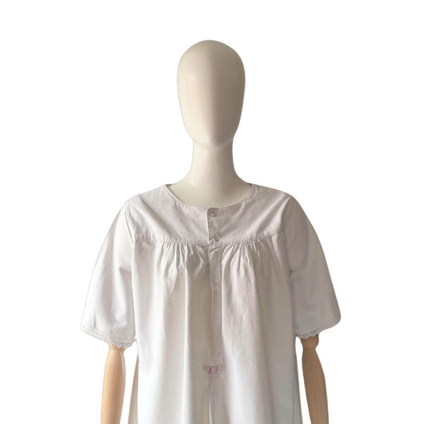 White antique chemise on a mannequin against a white background