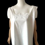 White edwardian antique chemise on a mannequin against a black background