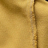 Close-up of yellow vintage blouse with a zigzag stitch