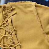 Close-up of mustard yellow vintage 1940s 1950s blouse with construction stitches