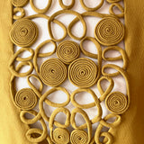 Decorative vintage blouse bib with interlocking circular rouleaux patterns on a white background