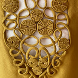 Decorative vintage blouse bib with interlocking circular rouleaux patterns on a white background