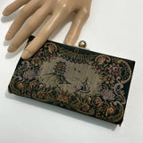 mannequi-hand-holding-a-vintage-1950s-needlepoint-clutch-bag-with-brass-frame-by-peck-and-peck-fifth-avenue-on-white-background-at-hurdyburdy-shop