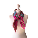 Shocking pink vintage Venice souvenir scarf featuring scenes and gondolas on white mannequin.